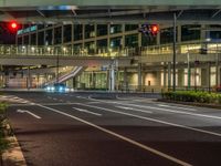 an image of outside of the night time building with the lights turned on and the streets empty