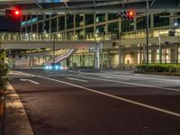 an image of outside of the night time building with the lights turned on and the streets empty