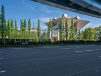 the city of richmond has long white arrows running down it's side and a pedestrian crossing over an expressway