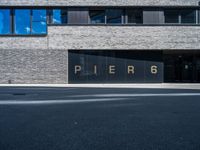 a large window in a building in front of a parking lot with the word pier 6 written on it