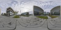 the distorted picture is the main focals for each camera on the photo, and shows an individual riding down a pathway in front of the building