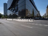 a man is skateboarding down a city street by the side of the road and there are many tall buildings behind him