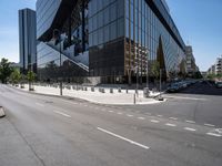 a man is skateboarding down a city street by the side of the road and there are many tall buildings behind him