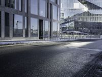 the shadow of a car is seen on the road near the building in the background