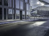 the shadow of a car is seen on the road near the building in the background