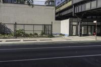 a couple of buildings sit near one another on a street side line in an urban area