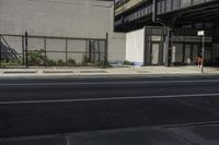 a couple of buildings sit near one another on a street side line in an urban area