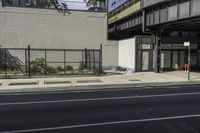 a couple of buildings sit near one another on a street side line in an urban area