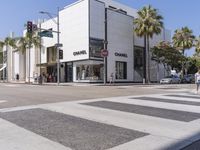 people are waiting at a crosswalk for a light to change on the street corner