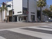 people are waiting at a crosswalk for a light to change on the street corner