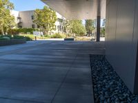 two grey blocks sitting next to a tall building on a sidewalk in front of grass