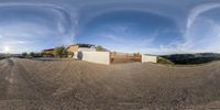 a 360 - view picture of an outside building that is reflecting its surroundings on the front and back walls