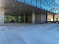 two grey blocks sitting next to a tall building on a sidewalk in front of grass