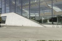 a person riding a skate board in an empty courtyard near the building with windows overlooking