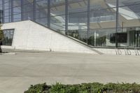 a person riding a skate board in an empty courtyard near the building with windows overlooking