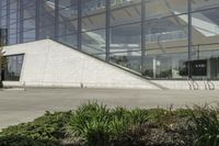 a person riding a skate board in an empty courtyard near the building with windows overlooking