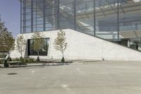 a person riding a skate board in an empty courtyard near the building with windows overlooking