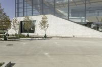 a person riding a skate board in an empty courtyard near the building with windows overlooking