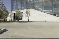 a person riding a skate board in an empty courtyard near the building with windows overlooking