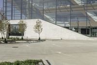 a person riding a skate board in an empty courtyard near the building with windows overlooking