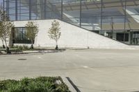 a person riding a skate board in an empty courtyard near the building with windows overlooking