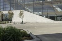 a person riding a skate board in an empty courtyard near the building with windows overlooking