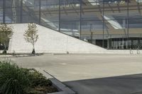 a person riding a skate board in an empty courtyard near the building with windows overlooking