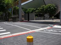 the yellow stop sign is on the side of the road in the city with no cars