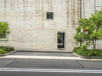 street corner in front of a brick building with no one outside it and a red stop sign