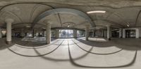 a room with multiple circular mirrors of the ceiling and columns in front of it with sunlight shining from the windows