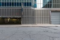 an open building with a door, two fire hydrant, and other buildings behind it