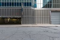 an open building with a door, two fire hydrant, and other buildings behind it