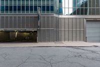 an open building with a door, two fire hydrant, and other buildings behind it