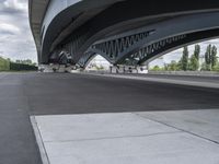 an overpass over a highway and the asphalt is gray and black color, with white dots