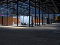 a room with a lot of glass walls and doors and people walking near by it