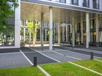 a building is shown with large columns and many bicycles parked outside the front door area