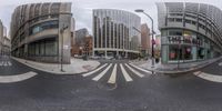 two panoramic mirrors with buildings in the background, on a city street corner