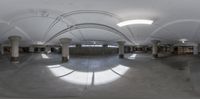 an old building with a curved ceiling is photographed in a fish eye view while it shows off the large mirror