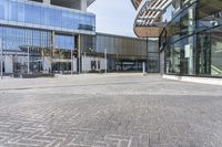 a large building that has a large glass window near it's entrance to a city