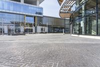 a large building that has a large glass window near it's entrance to a city