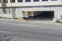 a stop sign in an empty parking garage space with a fence surrounding it to protect against the sun