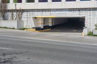 a stop sign in an empty parking garage space with a fence surrounding it to protect against the sun