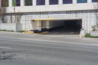 a stop sign in an empty parking garage space with a fence surrounding it to protect against the sun