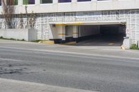 a stop sign in an empty parking garage space with a fence surrounding it to protect against the sun