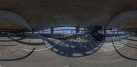 a fish - eye lens shows the view of some buildings and stairs in a city park