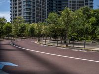 empty road with white lines on the streets of city area against cloudy blue sky on a sunny day