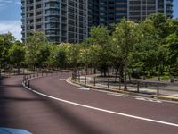 empty road with white lines on the streets of city area against cloudy blue sky on a sunny day