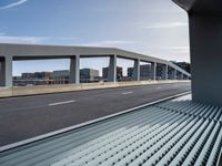 view of road from overpass overlooking city from car window seat area on train tracks