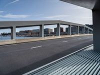 view of road from overpass overlooking city from car window seat area on train tracks