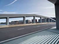 view of road from overpass overlooking city from car window seat area on train tracks